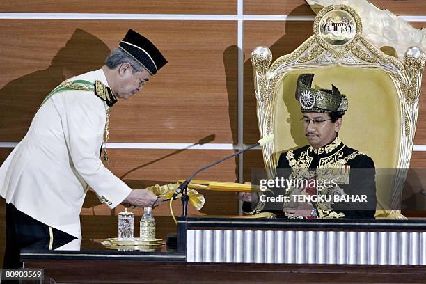 Malaysia's King, Tuanku Mizan Zainal Abidin receives a document containing his parliamentary opening speech from Malaysian Prime Minister Abdullah...
