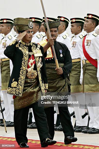 Malaysia's King, Tuanku Mizan Zainal Abidin salutes as he inspects the Royal Malay Regiment Guard of Honour as he officiates the first parliamentary...