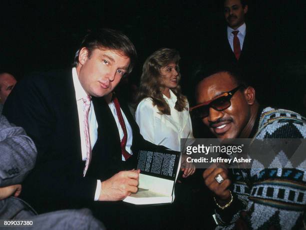 Businessman Donald Trump signs his book The Art Of The Deal for Boxer Evander Holyfield, Mistress Marla Maples ringside at Tyson vs Williams...