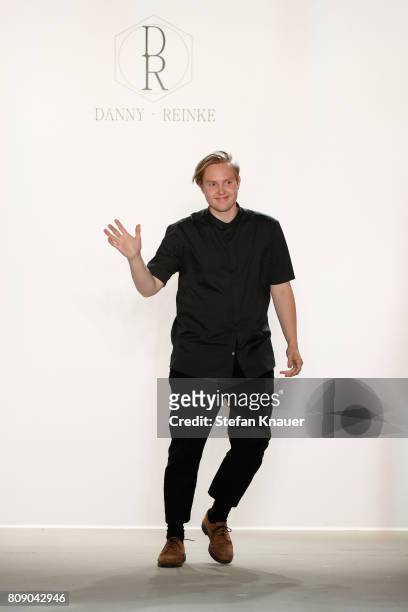 Designer Danny Reinke acknowledges the applause of the audience at the Danny Reinke show during the Mercedes-Benz Fashion Week Berlin Spring/Summer...