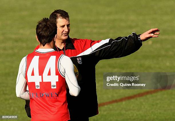 Ross Lyon the coach of the Saints speaks to Stephen Milne during a St Kilda Saints AFL training session at Linen House Oval on April 29, 2008 in...