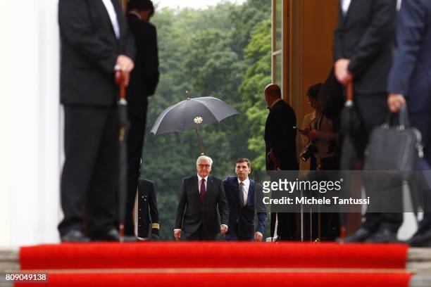 German President Frank-Walter Steinmeier waits for Chinese President Xi Jinping and his wife Peng Liyuan at Schloss Bellevue presidential palace on...