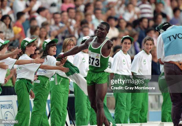 Nigerian athlete Ajibola Adeoye is congratulated after winnning the 100 metres event for single-arm amputees at the Summer Paralympics in Barcelona,...