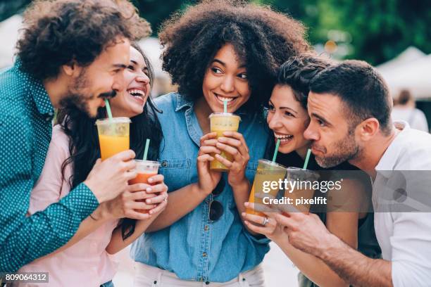 group of friends drinking smoothies - drinking smoothie stock pictures, royalty-free photos & images