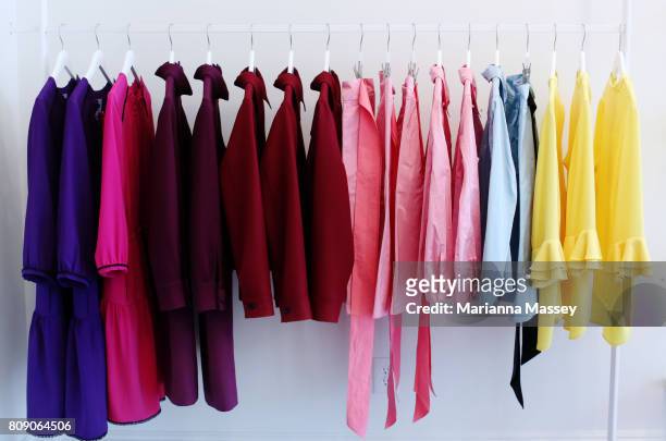colorful clothes for sale in a boutique - clothes hanging on rack at store for sale foto e immagini stock