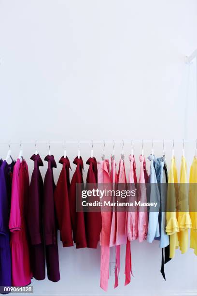 colorful clothes for sale in a boutique - clothes hanging on rack at store for sale foto e immagini stock