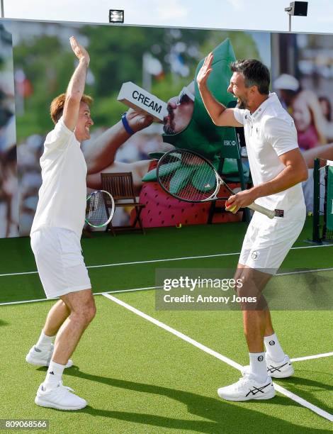 Anton du Beke and Goran Ivanisevic pose for pictures during a tennis lesson to promote HSBC's sponsorship of Wimbledon on HSBC Court 20 at the All...