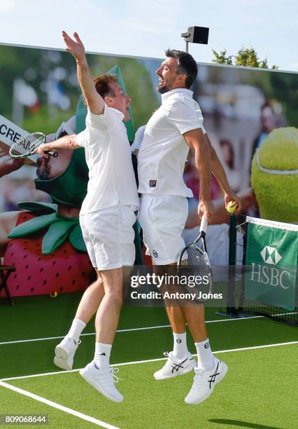 Anton du Beke and Goran Ivanisevic pose for pictures during a tennis lesson to promote HSBC's sponsorship of Wimbledon on HSBC Court 20 at the All...