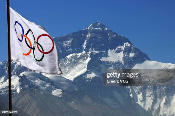 An Olympic flag waves in front of Mt. Qomolangma from the media center at the Rongbuk Base Camp as organisers prepare to cover the ascent of the...