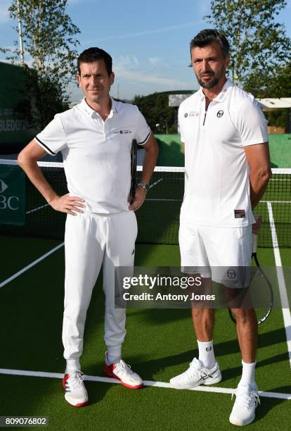 Tim Henman,Goran Ivanisevic pose for pictures during a tennis lesson to promote HSBC's sponsorship of Wimbledon on HSBC Court 20 at the All England...