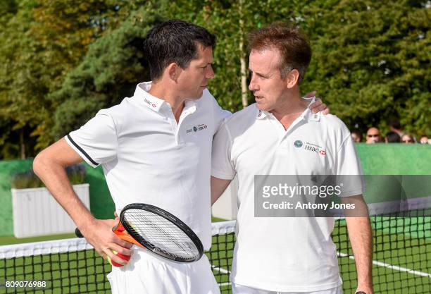 Tim Henman and Anton du Beke pose for pictures during a tennis lesson to promote HSBC's sponsorship of Wimbledon on HSBC Court 20 at the All England...