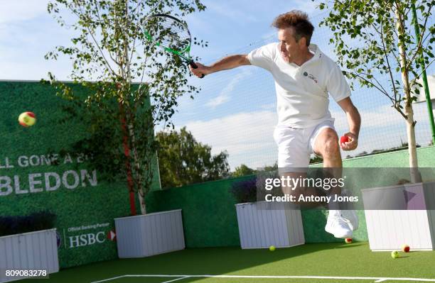 Anton du Beke pose for pictures during a tennis lesson to promote HSBC's sponsorship of Wimbledon on HSBC Court 20 at the All England Lawn Tennis and...