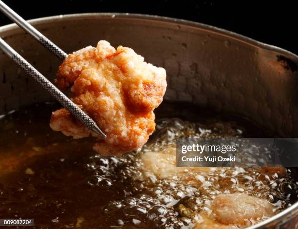 japanese fried chicken karaage being lifted - deep fried stock pictures, royalty-free photos & images