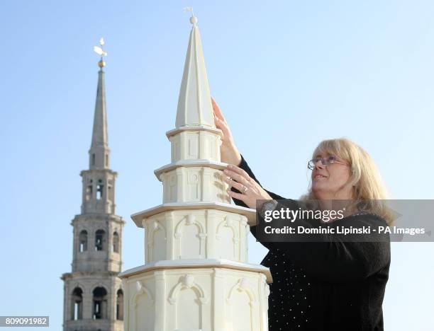 Cake maker Dawn Blunden, from Sophisticake, places the top on a four foot high medieval wedding cake, which replicates the steeple and spire of St...