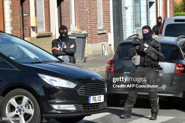 Police officers of an anti-terrorim unit and of French intelligence agency patrol in a street on Wattignies, northern France, after a man was...