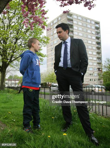 Labour Party Leader Ed Miliband meets Bradley Corby, aged 9, during a visit to a council estate in the Collyhurst area of Manchester.