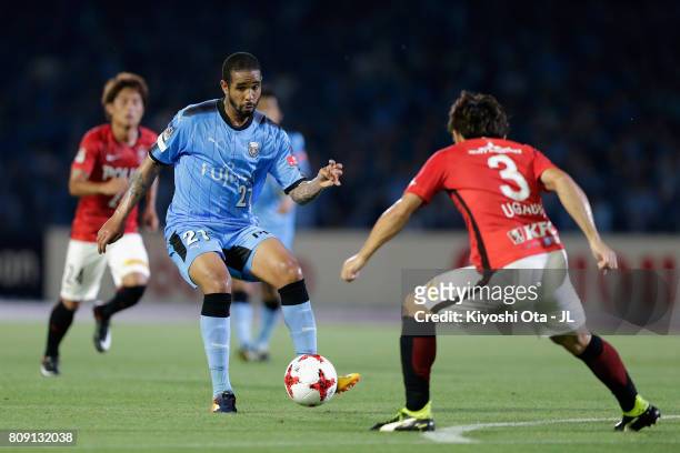 Eduardo Neto of Kawasaki Frontale takes on Tomoya Ugajin of Urawa Red Diamonds during the J.League J1 match between Kawasaki Frontale and Urawa Red...