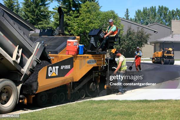 road crew and equipment in residential area - asphalt paver stock pictures, royalty-free photos & images