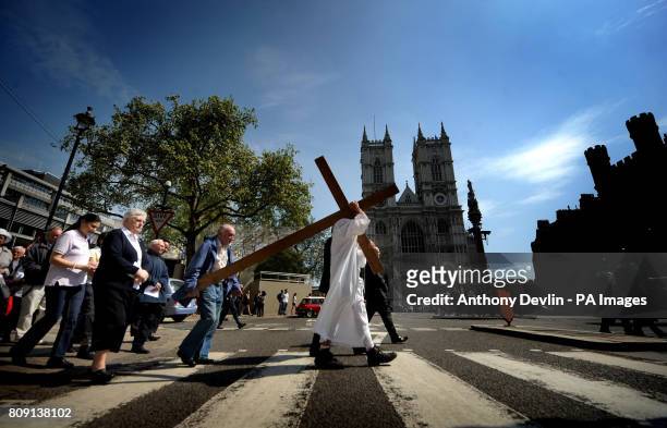 Cross is carried from Methodist Central Hall, past Westminster Abbey to Westminster Cathedral during the Crucifixion on Victoria Street, an...