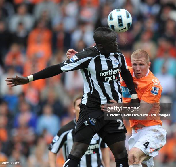 Blackpool's Keith Southern and Newcastle United's Shola Ameobi battle for the ball during the Barclays Premier League match at Bloomfield Road,...