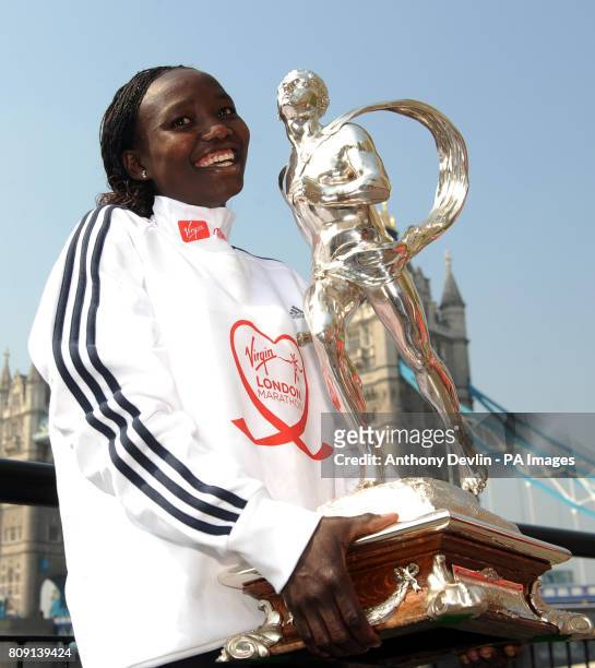 Winner of the Women's 2011 London Marathon Mary Keitany poses with the trophy beside Tower Bridge during the 31st Virgin London Marathon winners...
