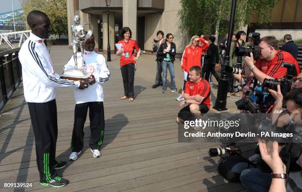 Winners of the Men's and Women's 2011 London Marathon Emmanuel Mutai and Mary Keitany pose with the trophy beside Tower Bridge during the 31st Virgin...