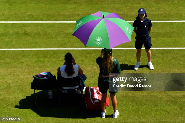 Maria Sakkari of Greece is shielded from the sun during the Ladies Singles second round match against Kristyna Pliskova of the Czech Republic on day...