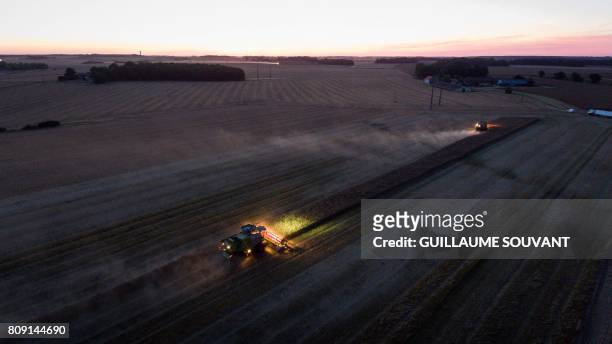 An aerial picture shows a combine harvester during a rape harvest on July 4, 2017 near Monthodon, central France.