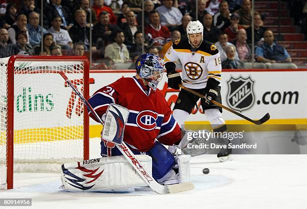 Goaltender Carey Price of the Montreal Canadiens makes a save as Marco Sturm of the Boston Bruins looks for the rebound during game seven of the 2008...