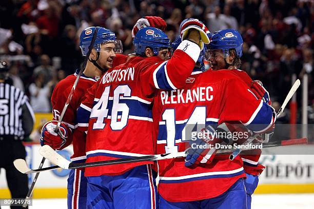 Sergei Kostitsyn of the Montreal Canadiens celebrates his goal with teammates, left to right, Josh Gorges, Andrei Kostitsyn and Tomas Plekanec during...
