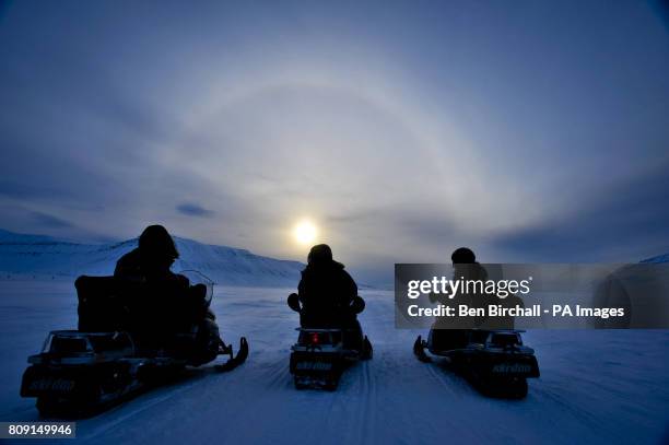 People on ski-doo's admire a halo, also known as a nimbus, icebow or Gloriole, which is an optical phenomenon produced by ice crystals in cirrus...