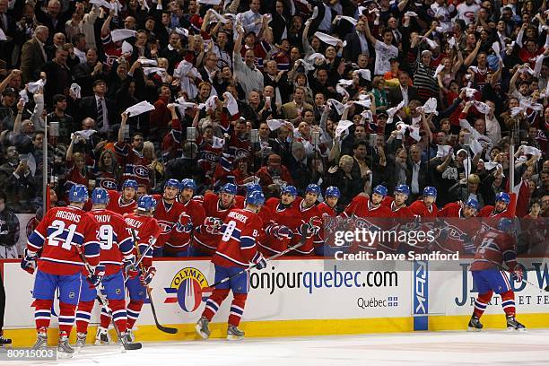 Members of the Montreal Canadiens skate by the bench area to celebrate after a play during game seven of the 2008 NHL Eastern Conference...