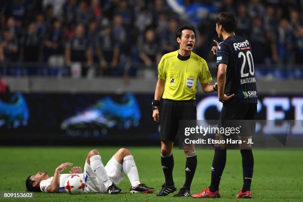 Shun Nagasawa of Gamba Osaka talks with referee Hiroyuki Kimura during the J.League J1 match between Gamba Osaka and Kashima Antlers at Suita City...