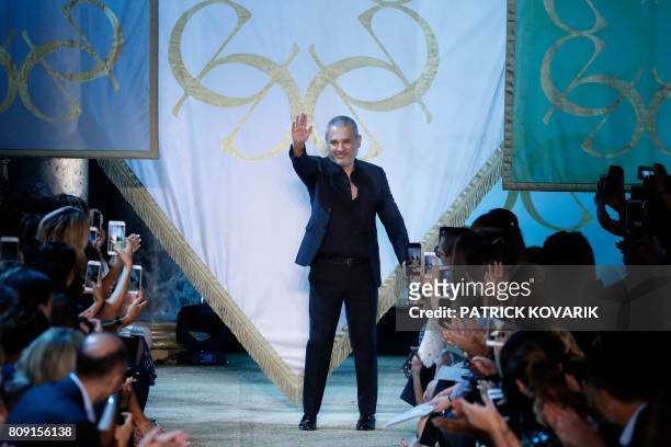 Lebanese designer Elie Saab acknowledges the audience at the end of the 2017-2018 fall/winter Haute Couture collection in Paris on July 5, 2017.