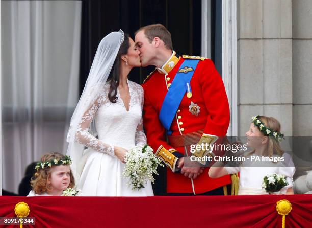 Prince William and his wife Kate Middleton, who has been given the title of The Duchess of Cambridge, kiss on the balcony of Buckingham Palace,...