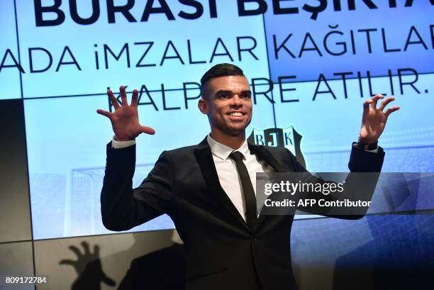 Besiktas' new Portuguese defender Pepe gestures to mimic an eagle during his signing ceremoby with the club on July 5, 2017 at Vodafone Park stadium...