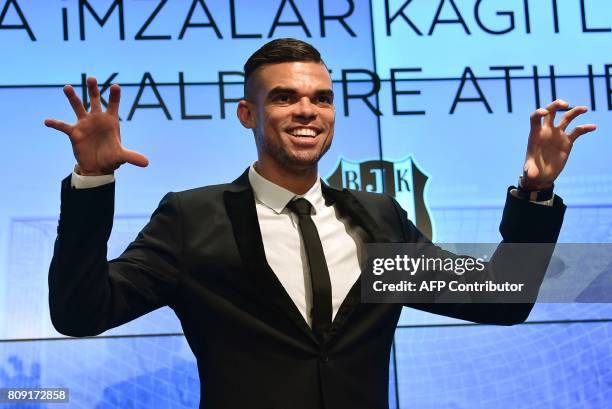 Besiktas' new Portuguese defender Pepe gestures to mimic an eagle during his signing ceremoby with the club on July 5, 2017 at Vodafone Park stadium...