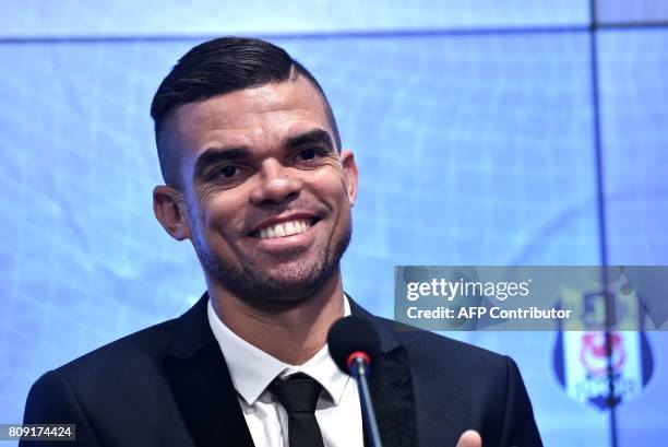 Besiktas' new Portuguese defender Pepe smiles during his signing ceremony with the club on July 5 at the Vodafone Park stadium in Istanbul....