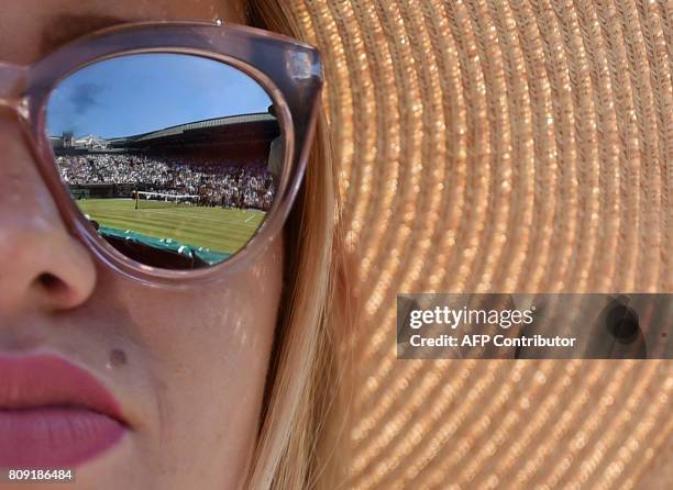 Court is reflected in the sunglasses of a spectator on the third day of the 2017 Wimbledon Championships at The All England Lawn Tennis Club in...
