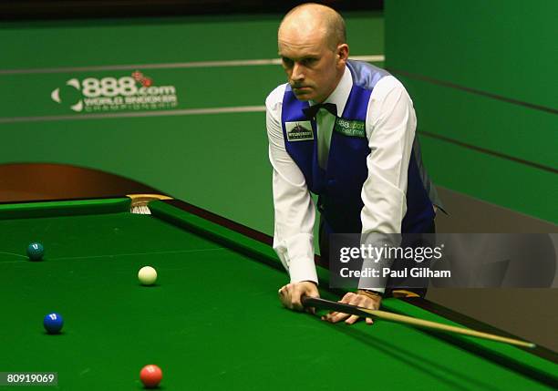 Peter Ebdon of England reflects on missing a black that would have put him on course for making a break of 147 against Ali Carter of England during...