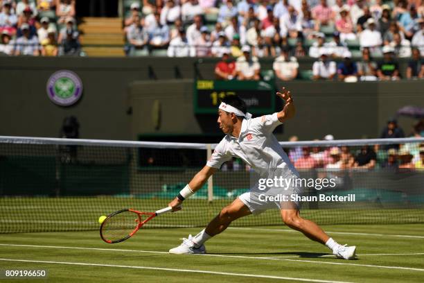 Kei Nishikori of Japan plays a backhand during the Gentlemen's Singles second round match against Sergiy Stakhovsky of Ukraine on day three of the...