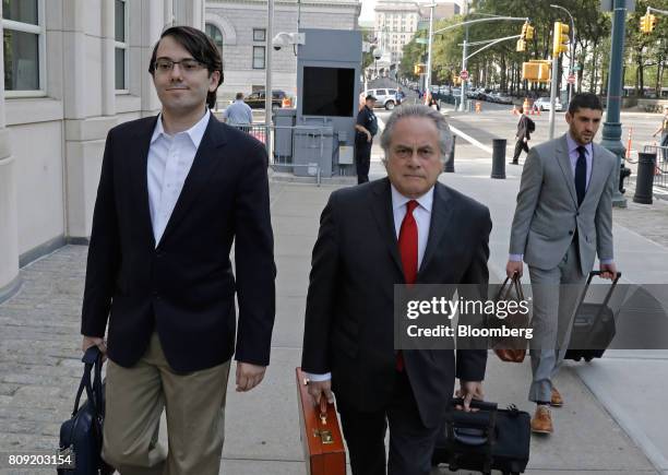 Martin Shkreli, former chief executive officer of Turing Pharmaceuticals AG, left, arrives at federal court with his attorney Benjamin Brafman,...