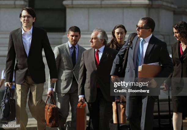 Martin Shkreli, former chief executive officer of Turing Pharmaceuticals AG, left, arrives at federal court with his attorney Benjamin Brafman,...