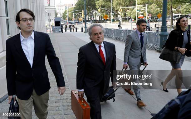 Martin Shkreli, former chief executive officer of Turing Pharmaceuticals AG, left, arrives at federal court with his attorney Benjamin Brafman,...