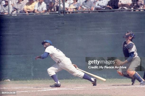 Lou Brock of the Chicago Cubs swings at a pitch during an MLB Spring Training game against the Los Angeles Dodgers circa April, 1962 in Mesa, Arizona.