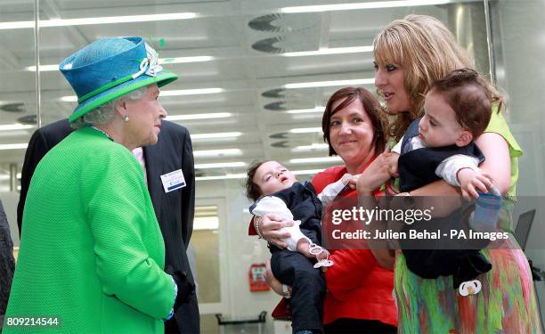 Queen Elizabeth II meets conjoined twins Hassan and Hussein Benhaffaf along with their mother Angie in the Tyndall Institute in Cork city today,...