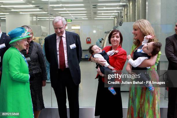 Queen Elizabeth II meets conjoined twins Hassan and Hussein Benhaffaf along with their mother Angie and Edward Kiely, the surgeon from Great Ormond...