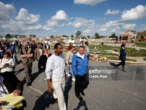 Virginia Gov. Timothy M. Kaine talks with homeowner Michael Henson as they walk past debris while touring the Hillpoint Farms subdivision to view...