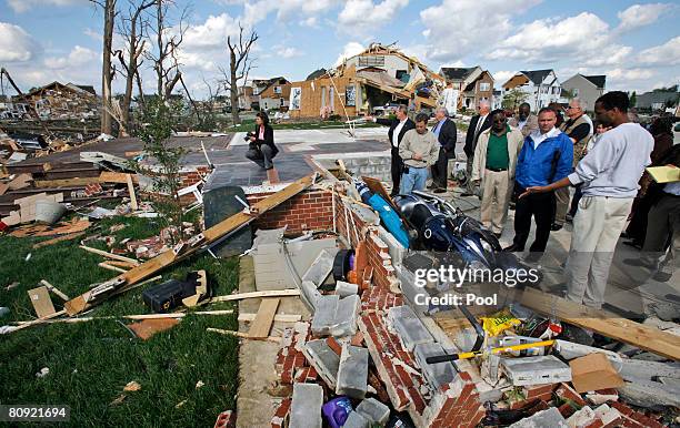 Virginia Gov. Timothy M. Kaine talks with homeowner Michael Henson as they walk past destroyed homes from a tornado while touring the Hillpoint Farms...