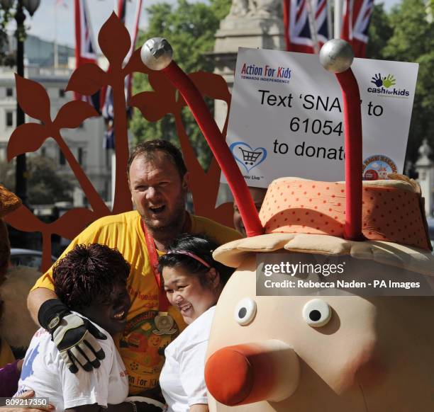 Charity fundraiser Lloyd Scott ceremoniously finishes the 2011 Virgin London Marathon after 26 days on the course dressed as a giant snail.